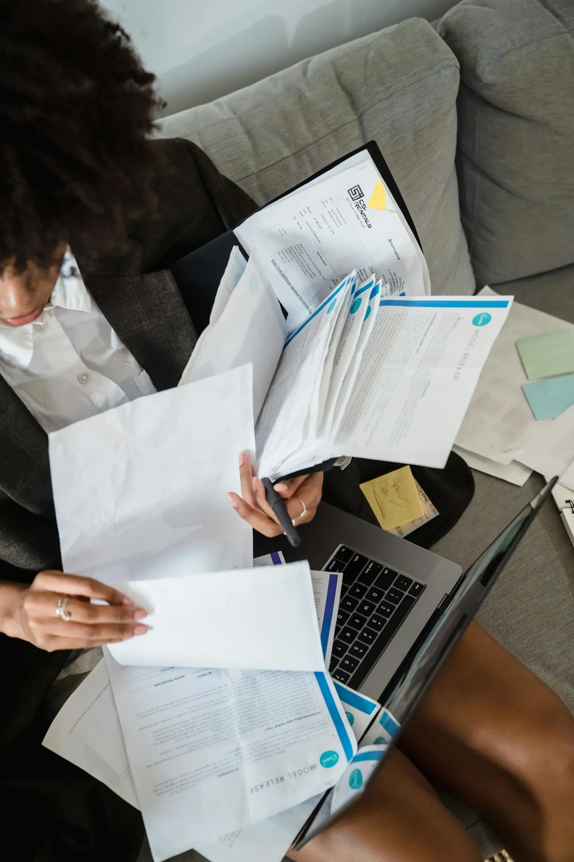 woman holding lot of paper and documents